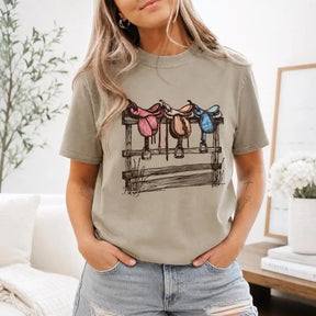 Vintage Western Saddles On Wooden Fence Graphic T-Shirt | Khaki Olive Horse Lover Cotton Tee