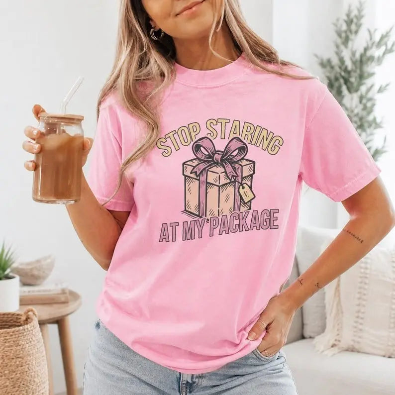 Stop Staring At My Package Funny Gift Graphic T-Shirt | Light Pink Holiday Humor Cotton Tee