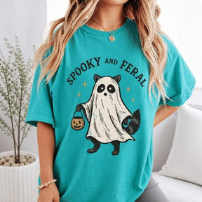 Spooky And Feral Ghost Racoon Halloween Graphic T-Shirt | Seafoam Teal Trick Or Treat Cotton Tee
