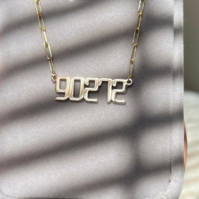 THE SIGNATURE “90272” NAMEPLATE NECKLACE