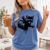 Raccoon In Trash Can Drip Graphic T-Shirt | Cornflower Blue Funny Trash Panda Cotton Tee