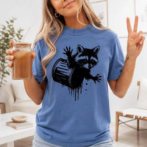Raccoon In Trash Can Drip Graphic T-Shirt | Cornflower Blue Funny Trash Panda Cotton Tee